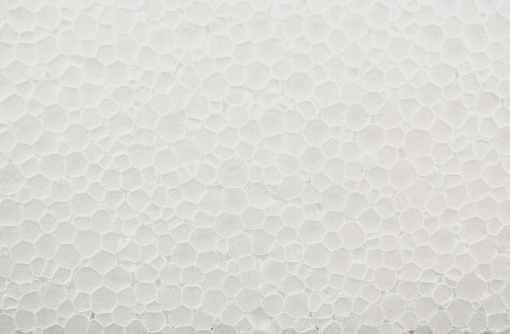 a close up of the surface of a white Polyfoam